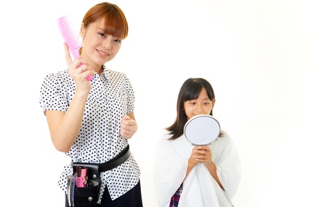 Haircutting girl in the hairdressing saloonの写真素材