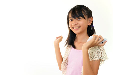 Happy young girl holding mobile phone の写真素材