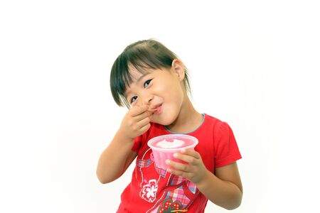 Happy kid eating sweetの写真素材