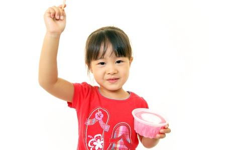 Happy kid eating sweetの写真素材