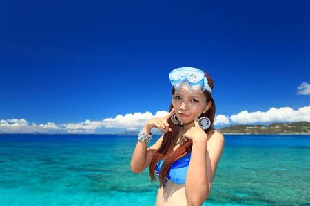 The woman who relaxes on the beach の写真素材