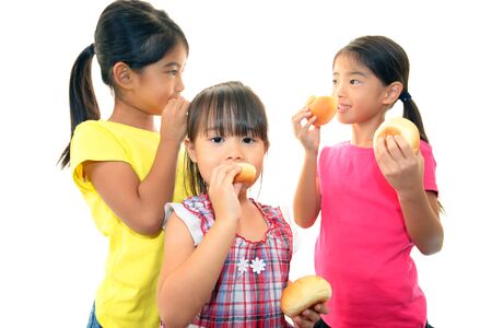 Little girls eating breadの写真素材