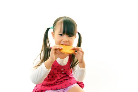 Happy kid eating sweetの写真素材