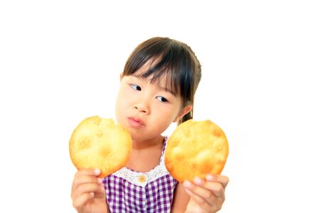 Happy kid eating sweetの写真素材