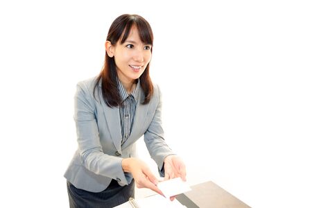 Smiling woman with business cardの写真素材