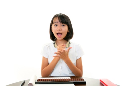 Smiling teenage girl using a laptopの写真素材