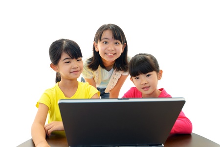 Smiling girls using a laptopの写真素材