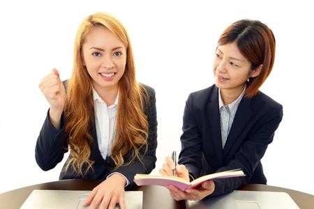 two women in conversation at the officeの写真素材