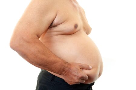 The obesity man who is worried about a stomachの写真素材