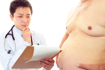 Serious doctor examining a patient obesityの写真素材