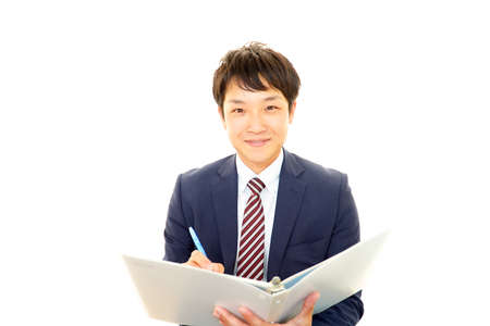 The male office worker who poses happilyの写真素材