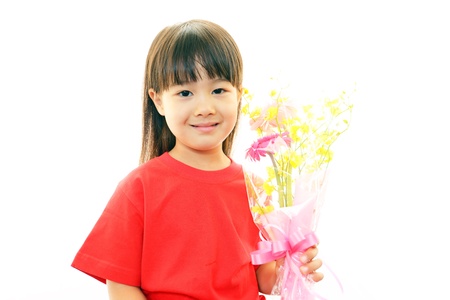 Joyful little girl holding present in handsの写真素材