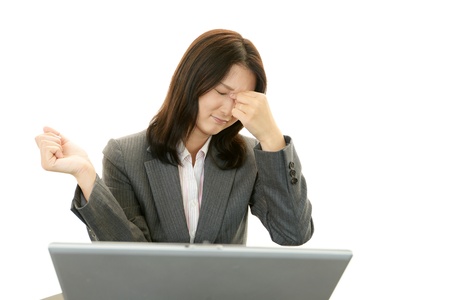 Tired and stressed young Asian womanの写真素材