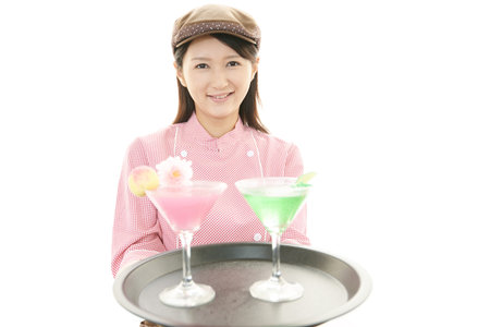 Smiling waitress carrying a cocktail
