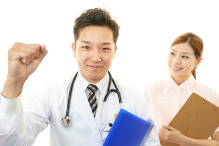Smiling doctor with nurseの写真素材