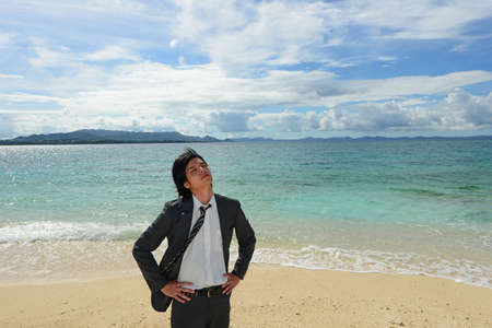 The man who relaxes on the beach 	の写真素材