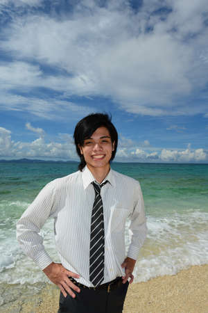 Portrait of happy young man on a tropical beach の写真素材