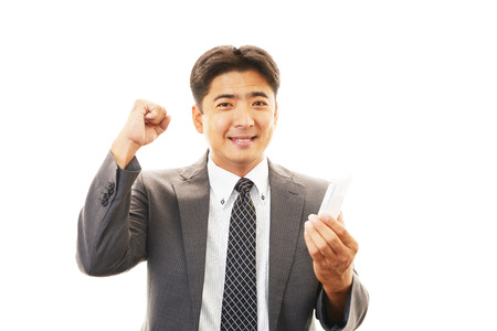 Happy business man using mobile phone の写真素材