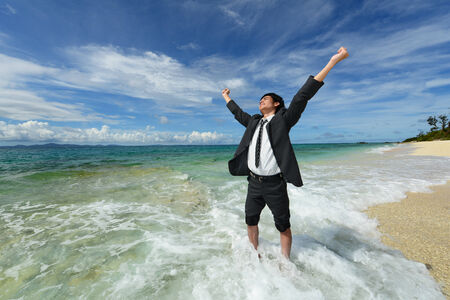 Portrait of happy young man on a tropical beach の写真素材