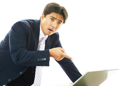 Surprised Asian businessmanの写真素材