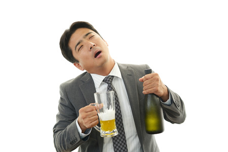 Drunk businessman man with beerの写真素材