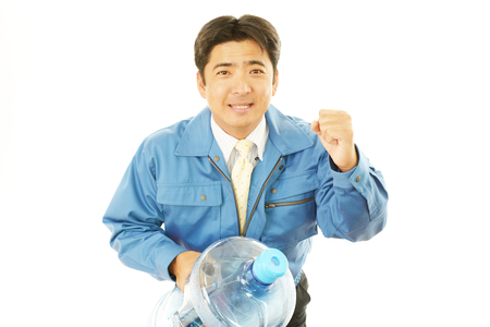 Worker with a container of water の写真素材