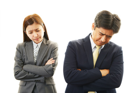 Dissatisfied businessman and businesswomen の写真素材