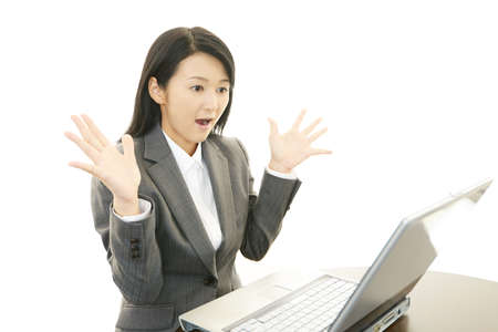 Surprised female office worker の写真素材