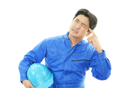 Worker having a headacheの写真素材