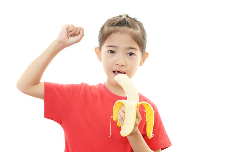 Smiling girl with fruitの写真素材