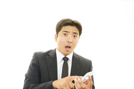 The male office worker who poses happilyの写真素材