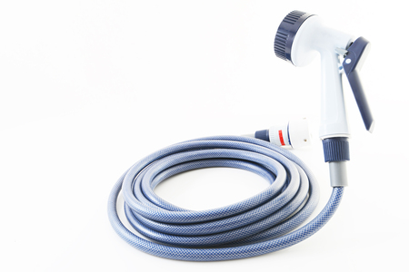 A garden hose with a sprayer on a white backgroundの写真素材