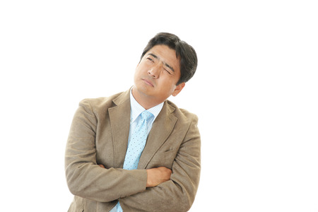 Tired and stressed Asian businessmanの写真素材