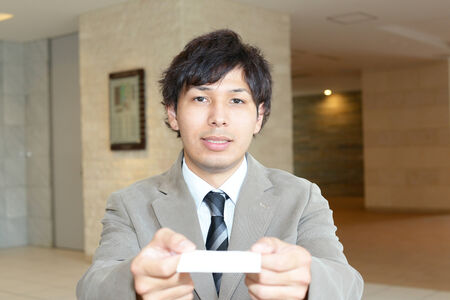Business man holding business cardの写真素材