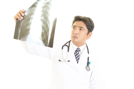 Doctor checking X-rayの写真素材