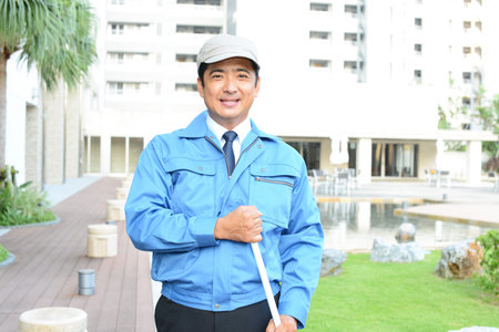 Smiling Asian janitor