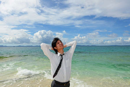 Young man on the beach enjoy sunlightの写真素材