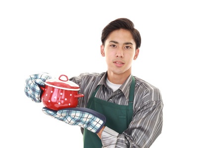 Asian man wearing kitchen apronの写真素材