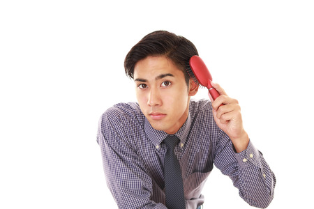 Man brushing his hairの写真素材