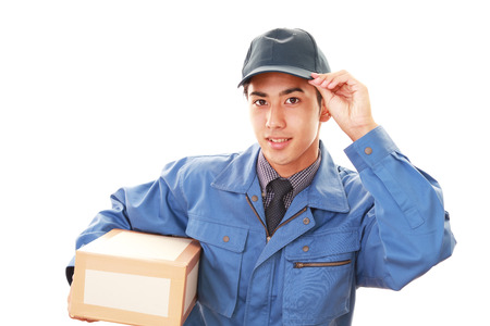 Smiling delivery man isolated on white backgroundの写真素材