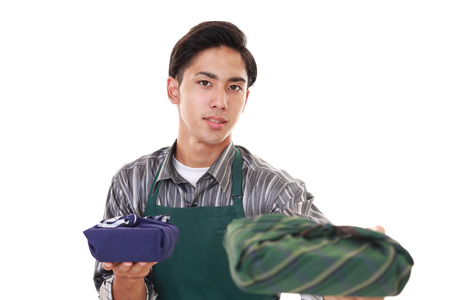 Asian man wearing kitchen apronの写真素材
