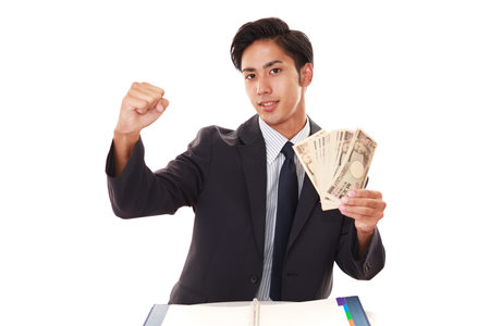 Smiling Asian businessman with moneyの写真素材