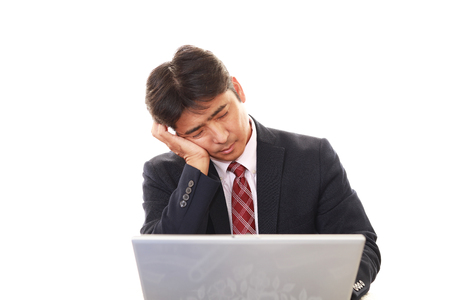Tired Asian businessmanの写真素材