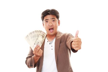 Smiling Asian man with moneyの写真素材