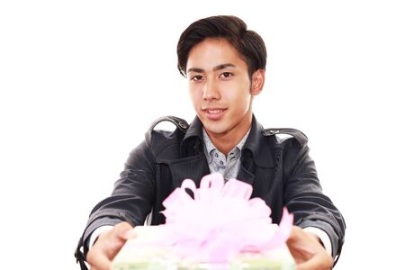 Smiling businessman with a giftの写真素材