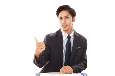 Asian business man showing thumbs up signの写真素材