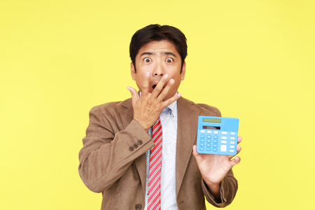 Surprised Asian businessmanの写真素材