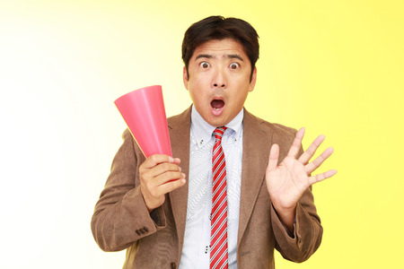 Surprised Asian businessmanの写真素材