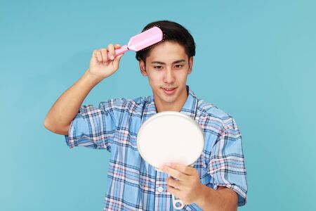 A man taking care of his hairの写真素材