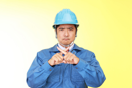 Asian worker shows the sign of prohibitionの写真素材